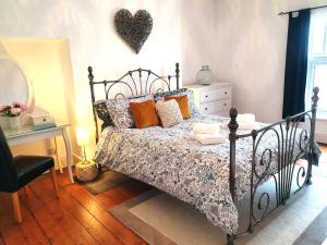 a bedroom with a bed with a heart on the wall at Coastal escape in the heart of Saltburn in Saltburn-by-the-Sea