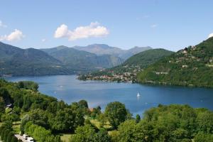a view of a lake in a valley with mountains at Piccolo Hotel Olina in Orta San Giulio