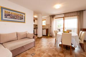a living room with a couch and a table at Apartments Smiljanic in Tribunj