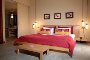 a bedroom with a large bed with red pillows at Ocean Beauty in Pereybere +22 photos