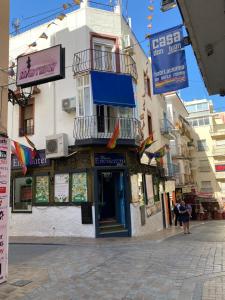 a building on the side of a street with flags at Alex Apartments in Benidorm