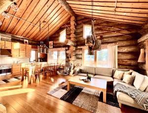 a living room with a couch and a table at Ruka View at the Slopes Ski in, Family & Bike Park, National Park, hike trails - Lapland Villas in Ruka