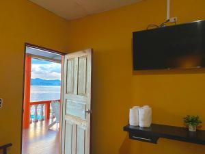 a room with a door and a view of the ocean at Hotel San Miguel in Flores