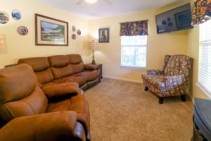 a living room with a couch and a chair at Little Bear Retreat 1 in Helen