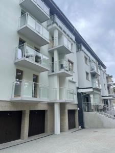 an apartment building with balconies on the side of it at Apartament Lili Słoneczne Tarasy in Dziwnówek