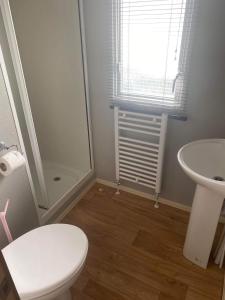 a bathroom with a toilet and a sink at The Pet Friendly Pad in Hunstanton