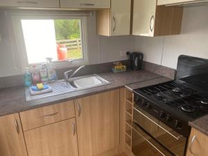 a kitchen with a sink and a stove and a window at The Pet Friendly Pad in Hunstanton