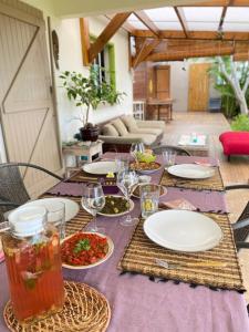 a table with plates of food and drinks on it at Villa calme et confortable avec vue océan in Saint-Leu