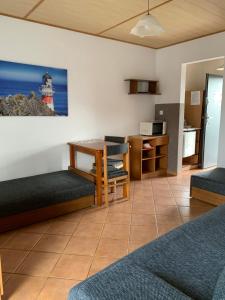 a living room with a table and chairs and a lighthouse at Fala in Karwia