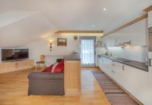 a living room with a couch and a kitchen at Gabriel in Ortisei