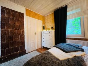 Łóżko lub łóżka w pokoju w obiekcie Ranczo Wilkowyja