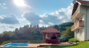 a house with a gazebo and a swimming pool at GardenLux Sarajevo in Sarajevo