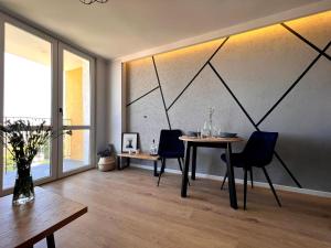 a dining room with a table and two chairs at Apartament M.55 in Gdynia