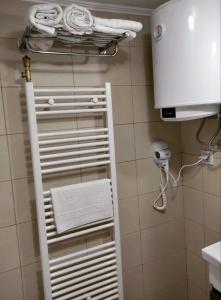 a white towel rack in a bathroom with a phone at Dream Home Studio Apartments in Tuzla