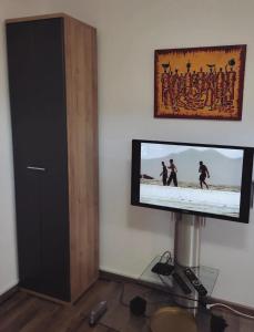a flat screen tv on a wall in a room at Dream Home Studio Apartments in Tuzla