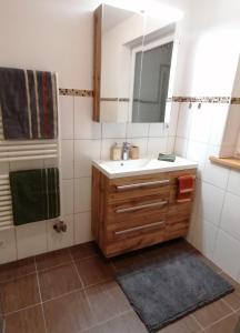 a bathroom with a sink and a mirror at Ferienwohnung Bauer in Böbing