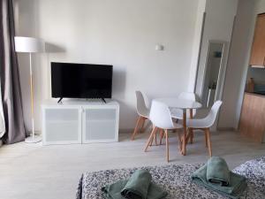 a living room with a tv and a table and chairs at Benal Beach 229 in Benalmádena