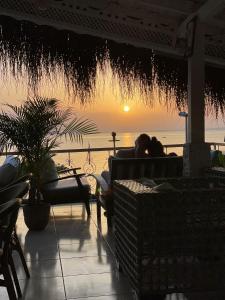 a man and a woman sitting on a couch watching the sunset at Cuba Beach Hotel in Side