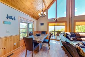 a dining room with a table and a couch at Sun Eagle Lodge in Bryson City