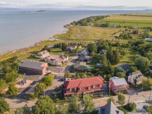 an aerial view of a small village next to the water at Auberge Akamaraska in Kamouraska