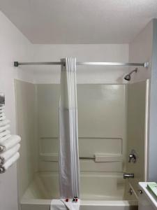 a shower with a shower curtain in a bathroom at Super 8 by Wyndham Trinidad in Trinidad