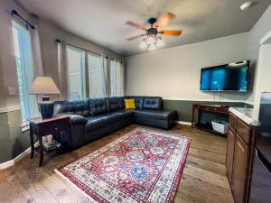 a living room with a couch and a flat screen tv at Jackson Creekside in Jacksonville