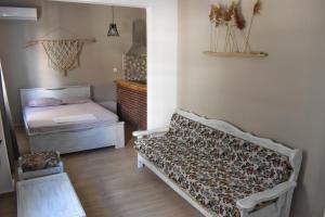 a room with a couch and a bed in it at Voula's House in Skiathos
