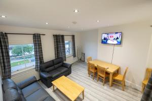 a living room with a couch and a table at Entire Two Double Bedrooms Flat with River Yare View H6 in Great Yarmouth