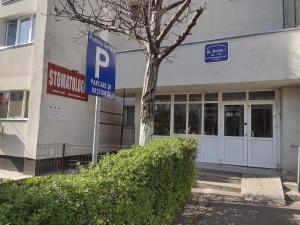a parking sign in front of a building at Delightful Studio Brâncuși in Bucharest
