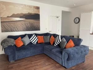 a blue couch with pillows in a living room at Harcourt Place in Scarborough