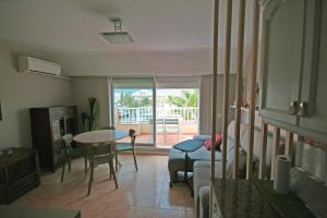 a living room with a table and chairs and a living room at Dúplex playa Torrenostra in Torreblanca