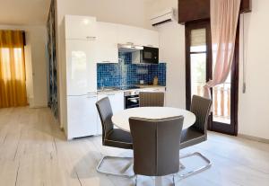 a kitchen with a table and chairs in a room at Noemi Holiday House in Agnone Bagni
