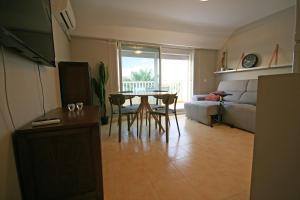 a living room with a table and a couch at Dúplex playa Torrenostra in Torreblanca