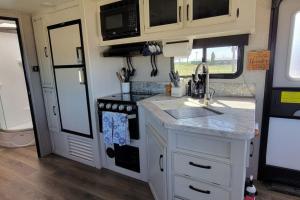 a kitchen with a sink and a stove in an rv at Brand New RV Bay Front in Port Lavaca