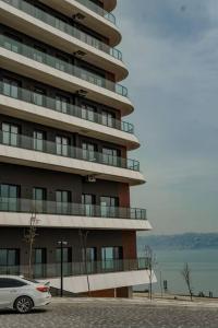 a car parked in front of a large building at Amazing Seafront new 4 Bedrooms flat with free Wi-Fi in Buyukcekmece