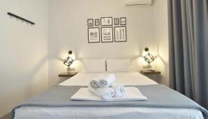 a bedroom with a bed with towels on it at Feel Athens Studios at Monastiraki in Athens
