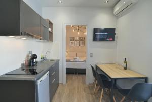 a kitchen with a table and a dining room at Feel Athens Studios at Monastiraki in Athens