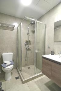 a bathroom with a shower and a toilet and a sink at Feel Athens Studios at Monastiraki in Athens