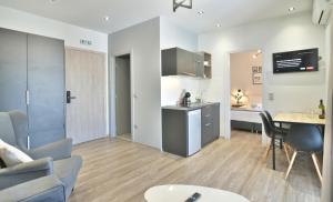 a living room with a kitchen and a dining room at Feel Athens Studios at Monastiraki in Athens