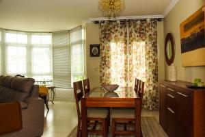 a living room with a dining room table and a couch at Miranda VUT-PO-004637 in Caldas de Reis