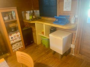 a kitchen with a desk and a small refrigerator at La Cabaña de Gaia in San Lorenzo de El Escorial +14 photos