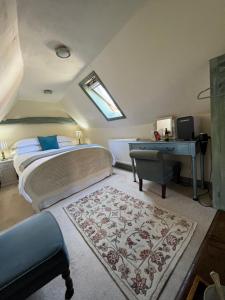 a bedroom with a bed and a desk and a table at The Tea House in Rye