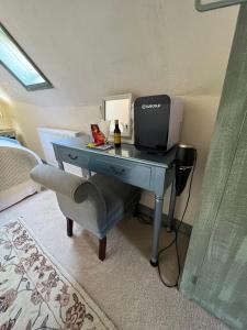 a desk with a computer on it in a room at The Tea House in Rye