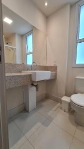 a bathroom with a sink and a toilet at Flat Hotel América Campos Pelinca in Campos dos Goytacazes +11 photos