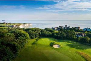 an aerial view of a green golf course at Self contained, spacious annex with private drive. in Kent