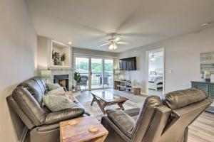 a living room with two leather couches and a table at Camdenton Condo with Pool Access and Lake Views! in Camdenton