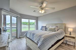 a bedroom with a bed and a ceiling fan at Camdenton Condo with Pool Access and Lake Views! in Camdenton