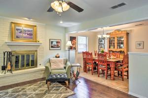 a living room with a fireplace and a dining room at Unique Ranch-Style Home Less Than 2 Mi to Downtown! in Canyon