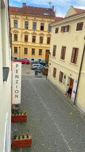 an empty street with a sign on the side of a building at Penzion Panská in České Budějovice