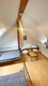 a attic room with a bed and a table at Penzion Panská in České Budějovice
